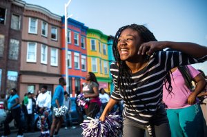 Photo of young woman in Baltimore, keeping a smile on her face.